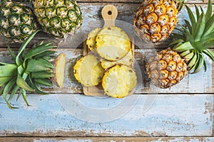 .Fresh pineapple fruit sliced Ã¢â¬â¹Ã¢â¬â¹on a wooden cutting board